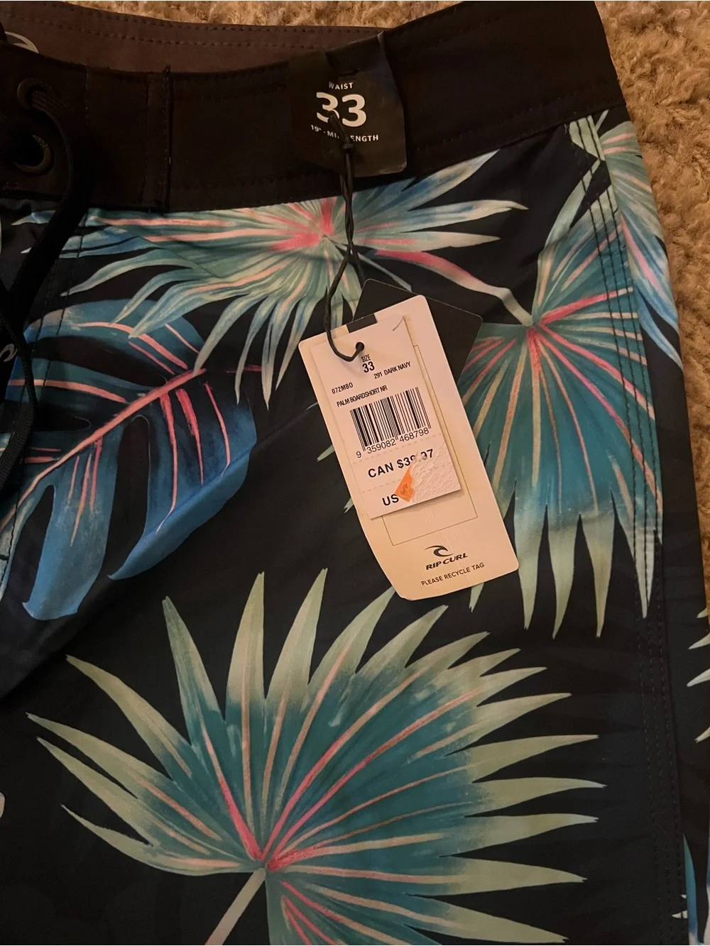 Rip Curl Black Swim Shorts with Blue-Green Tropical Leaves